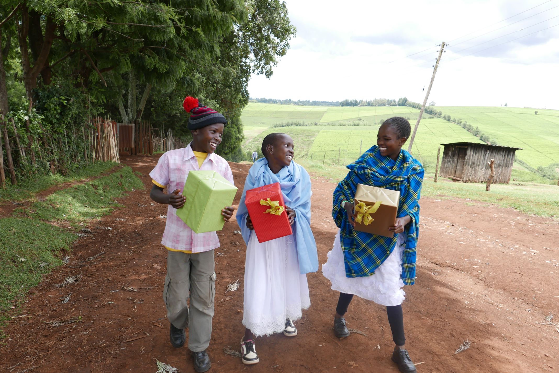 kids in africa walking with gifts